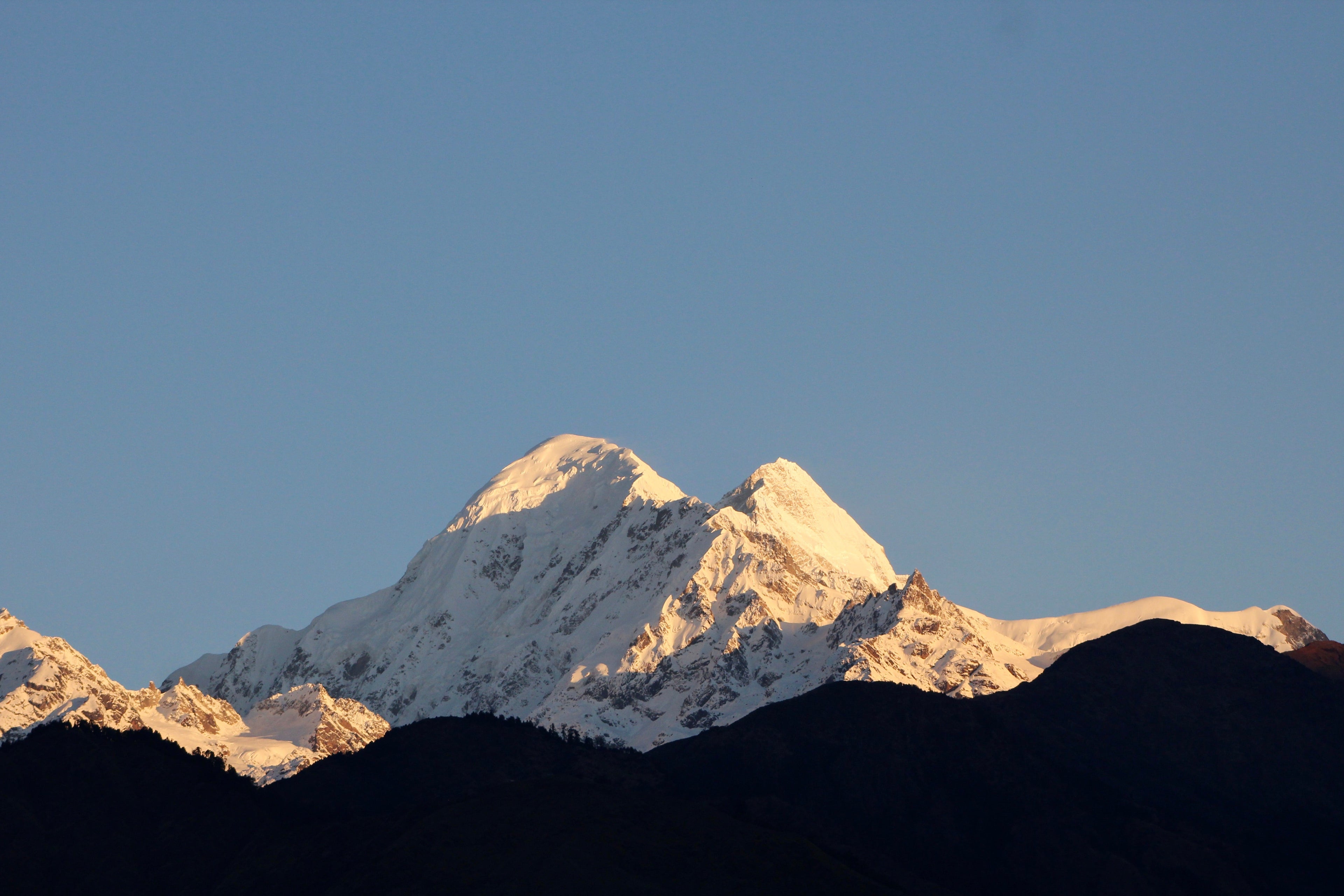 Snow-capped mountain peak with a clear blue sky
